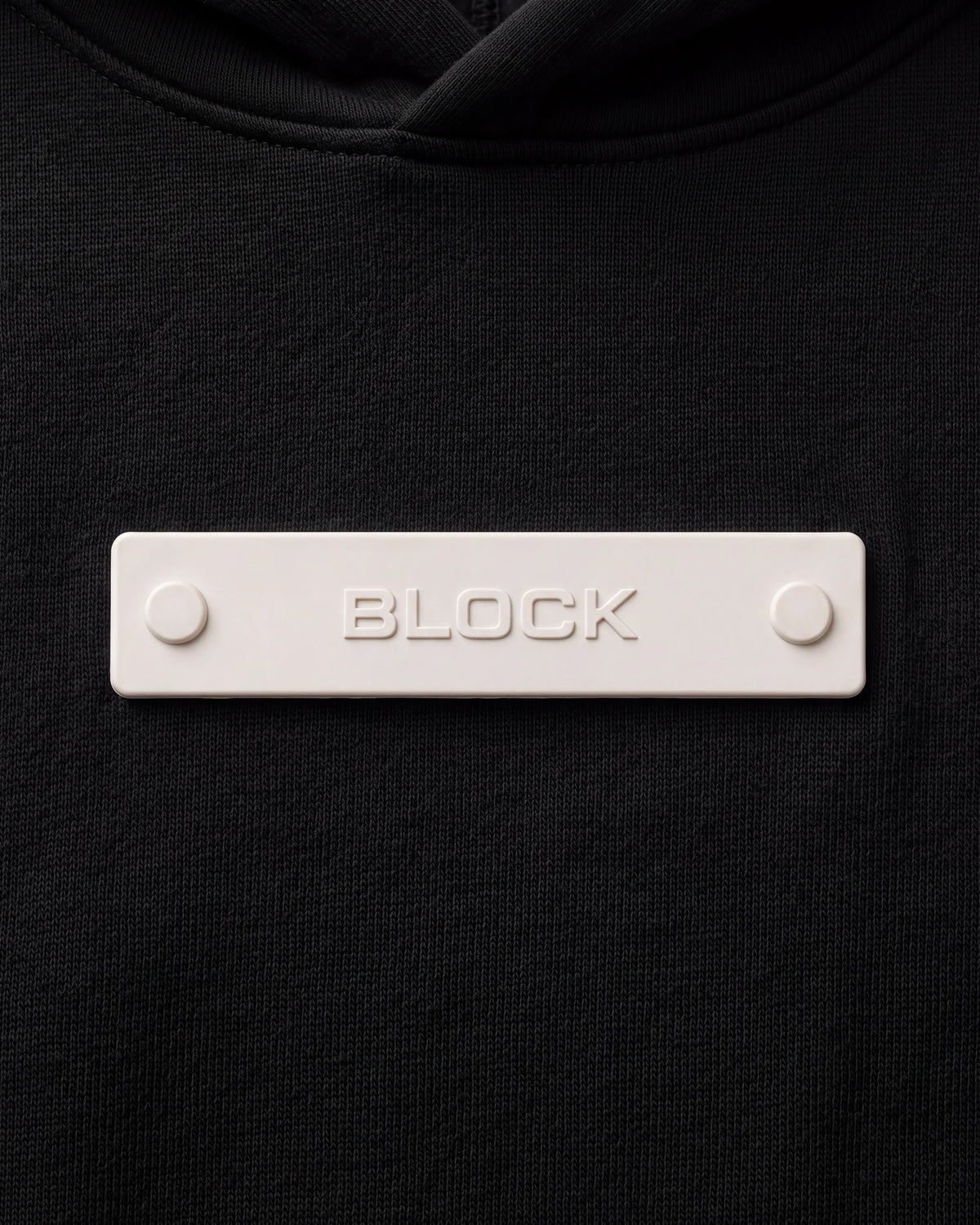 Banner 01 — Cream module mounted on black platform hoodie chest anchor