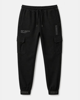Black — Cargo Pant 01 — laid flat, bellowed thigh pockets, hip module, cuff tabs